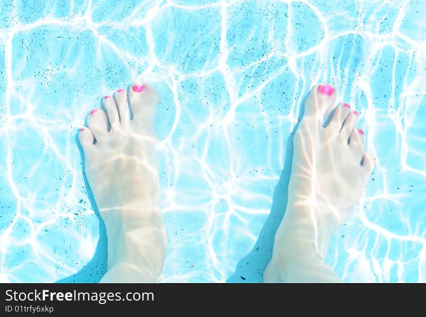 Woman feet in the pool. Woman feet in the pool