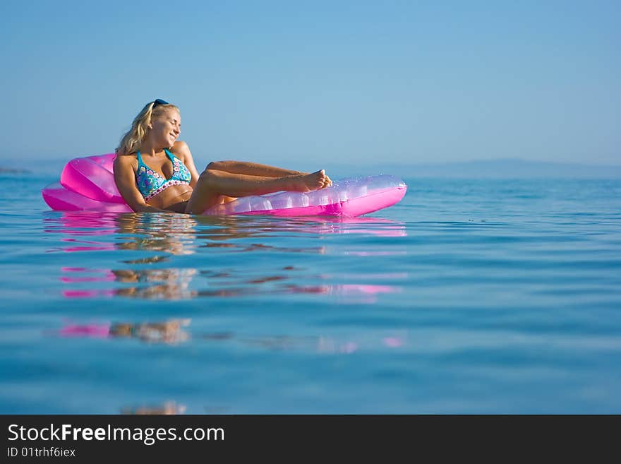 Blonde girl on inflatable raft