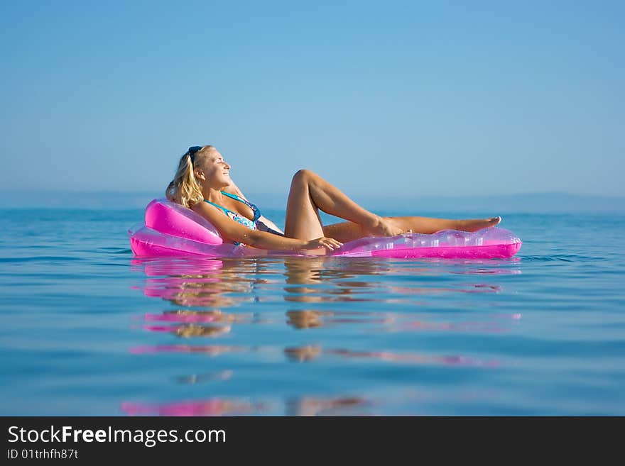 Blonde girl on inflatable raft