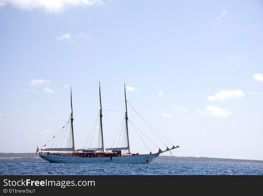 A sailing boat at the calm waters between Ibiza and Formentera (Spain). A sailing boat at the calm waters between Ibiza and Formentera (Spain)