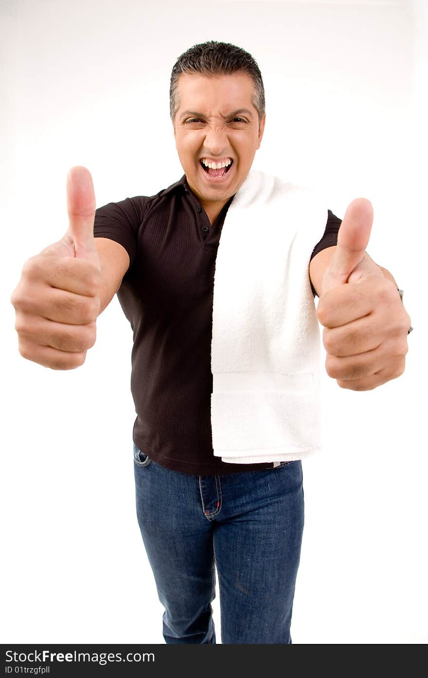 Happy male showing thumbs up with towel on shoulders