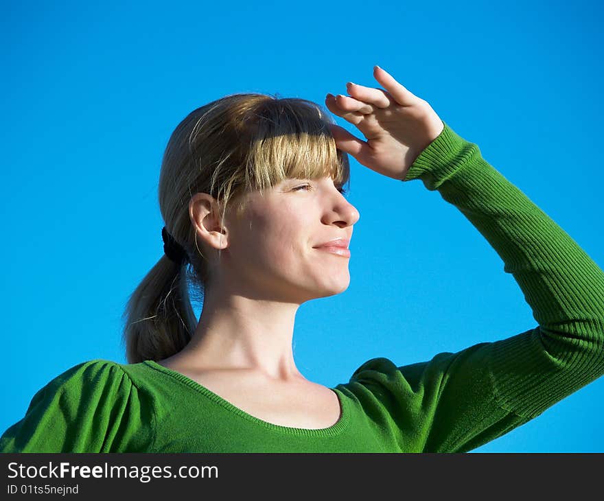 Portrait of the young woman posing on a background of the dark blue sky. Portrait of the young woman posing on a background of the dark blue sky