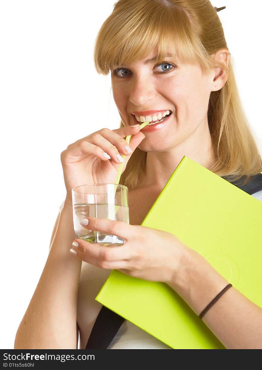 The young student drinks water from a glass on a white background. The young student drinks water from a glass on a white background