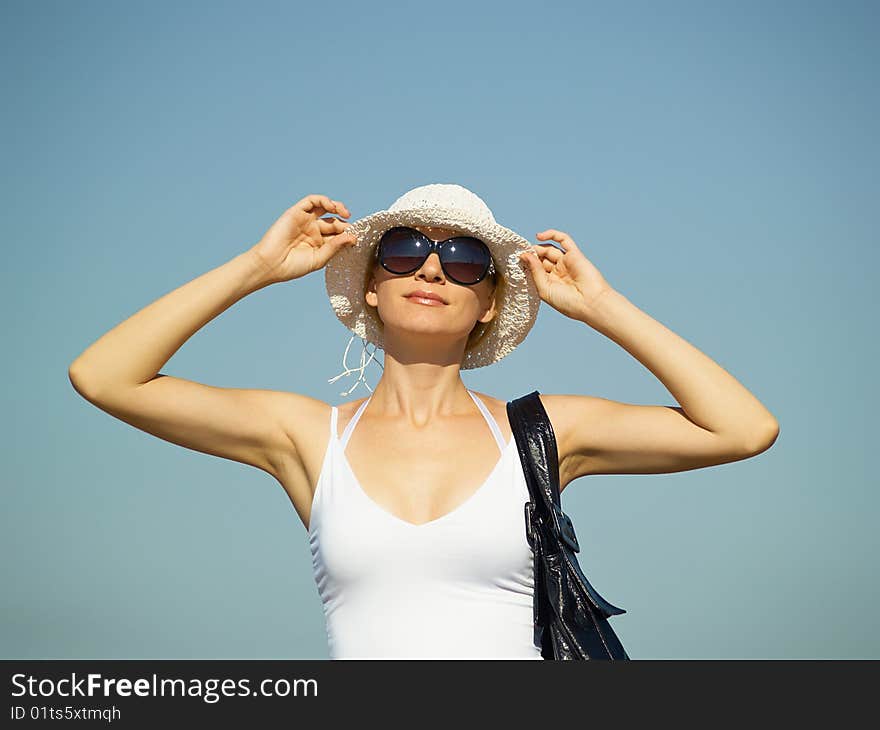 The young woman in white clothes on rest in the summer on the nature