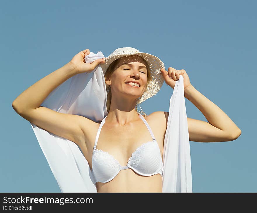 The young woman in white clothes on rest in the summer on the nature