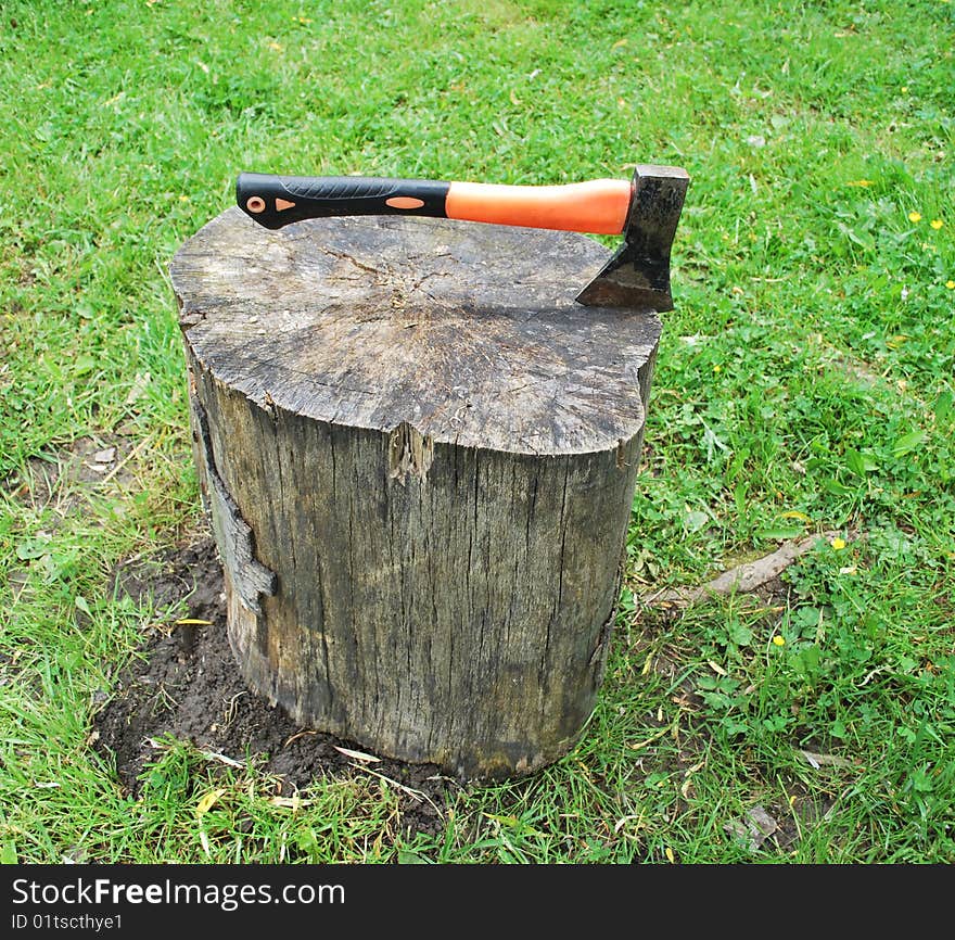 Axe in the block and Green Grass
