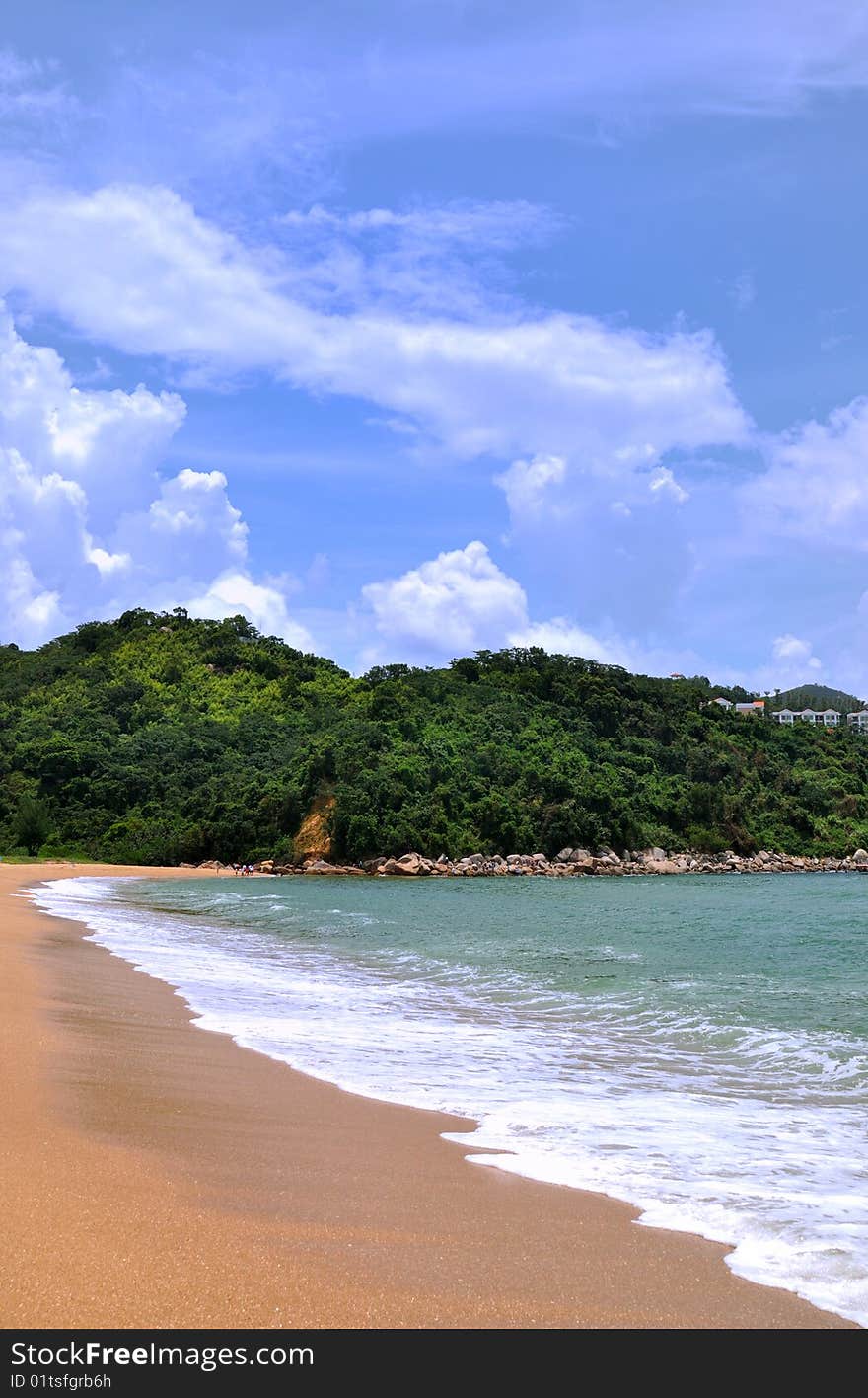 Sea and beach under blue sky and white cloud, hill beside beach, with green plant covered. wave and white foam as curve. Sea and beach under blue sky and white cloud, hill beside beach, with green plant covered. wave and white foam as curve.