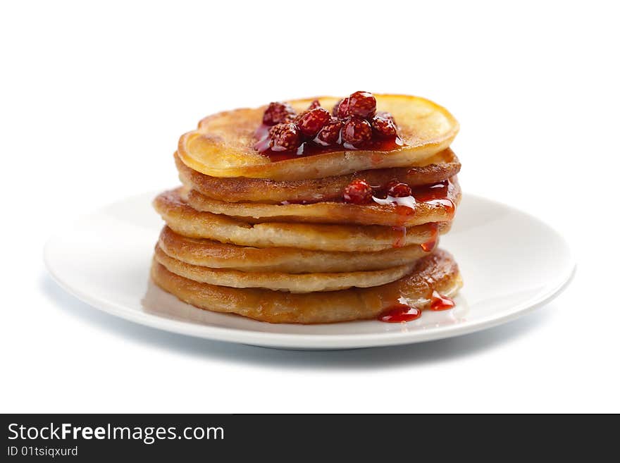 Sweet pancakes with strawberry jam isolated over white