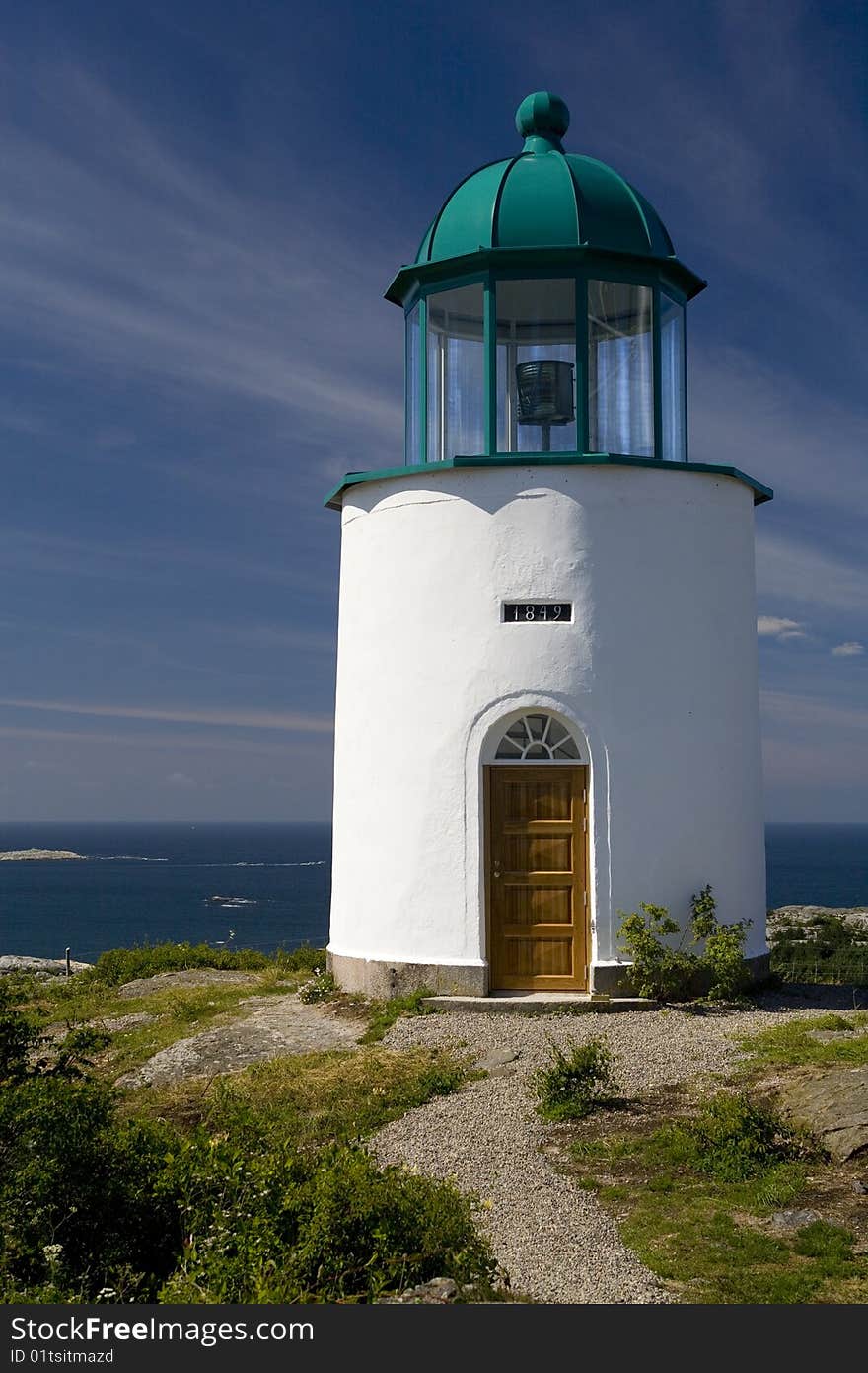 A small lighthouse on the island of North Koster with the Swedish archipelago in the background. A small lighthouse on the island of North Koster with the Swedish archipelago in the background.