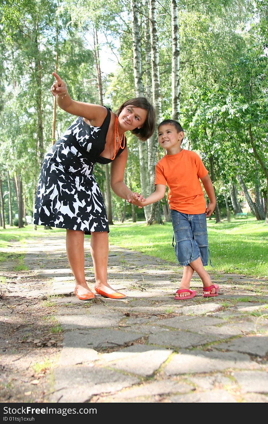 Mother with son walking in the forest