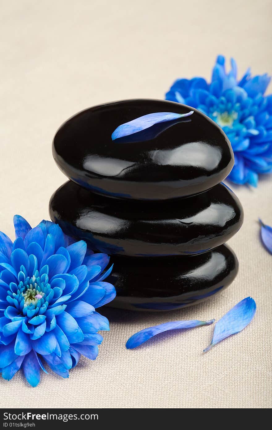 Black spa stones and flowers