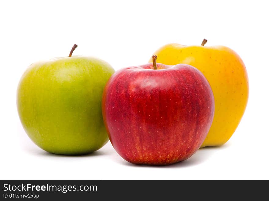 Red, yellow and green fresh apples on studio white