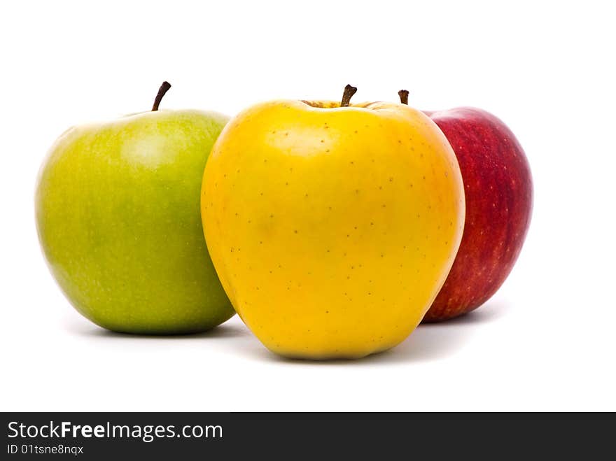 Red, yellow and green fresh apples on studio white