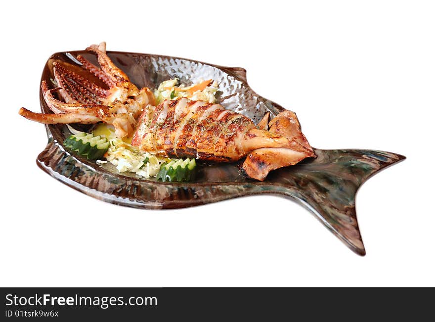 Seafood - Fresh Calamari with Salad on a plate shaped fish. Isolated on White Background