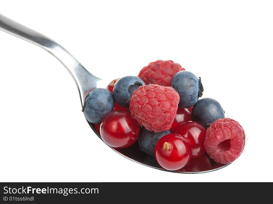 Fresh berries in spoon isolated over white