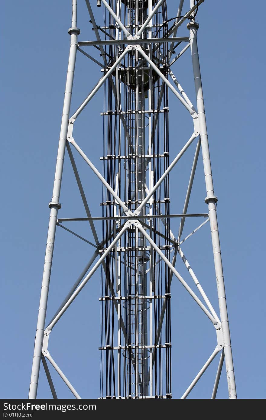 Part of a grey radio tower. Metal structure.