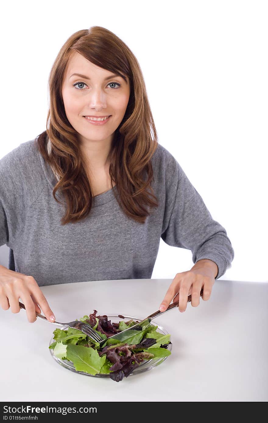 Woman eating a salad in a modern kitchen