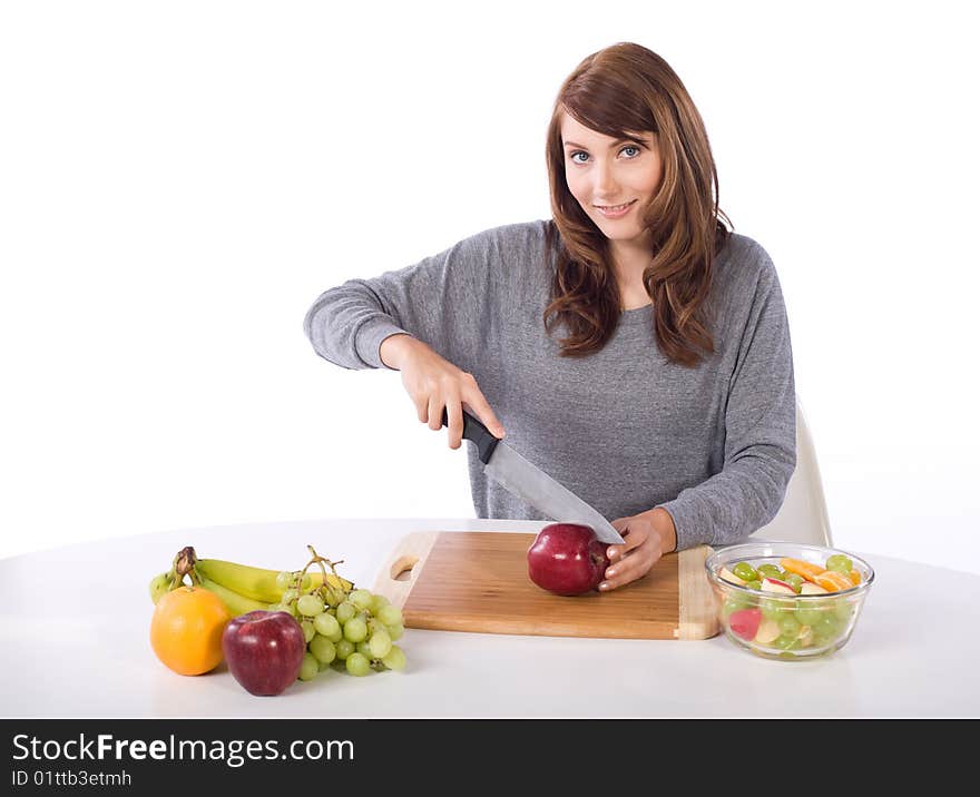 Woman cutting an apple for a fruit salad