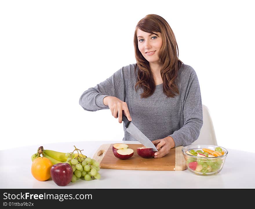 Woman cutting an apple for a fruit salad