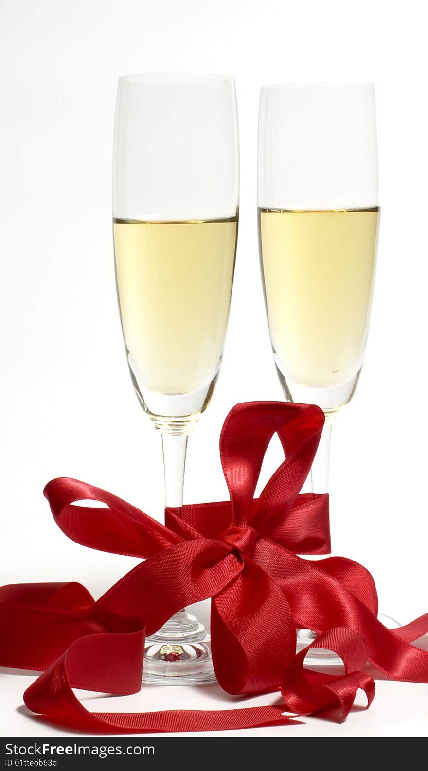 Pair glasses to a white wine are connected by a red tape on a white background. Pair glasses to a white wine are connected by a red tape on a white background