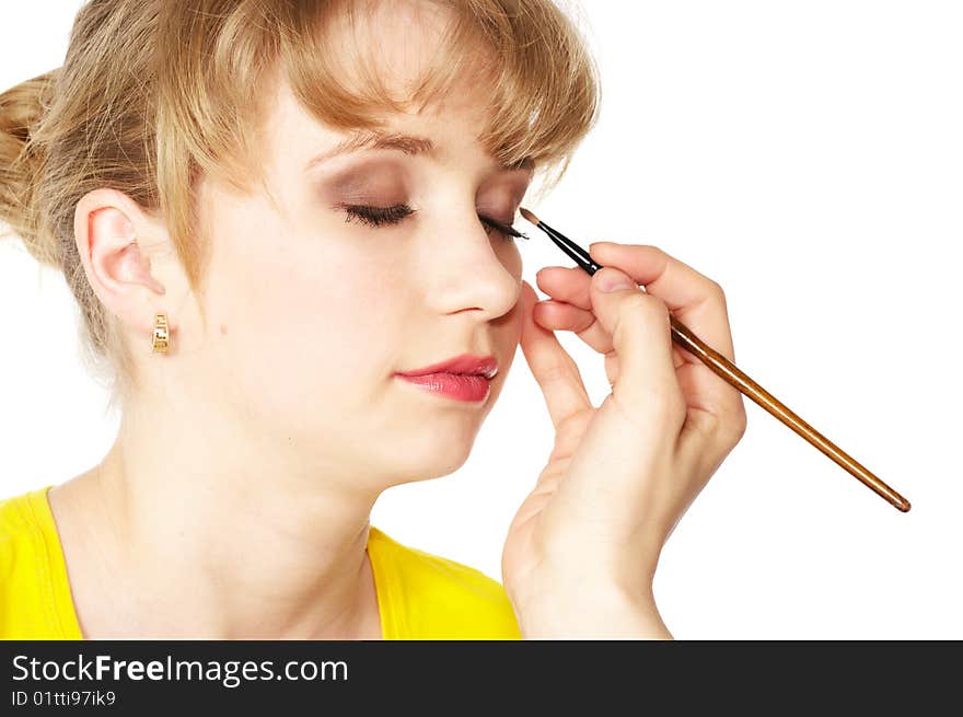 A girl having makeup applied. A girl having makeup applied