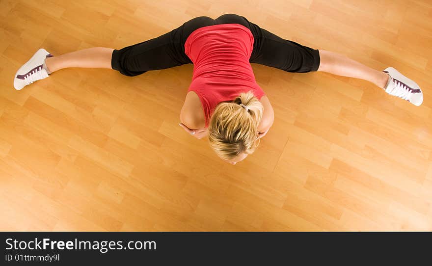 Beautiful blond women exercising on the floor