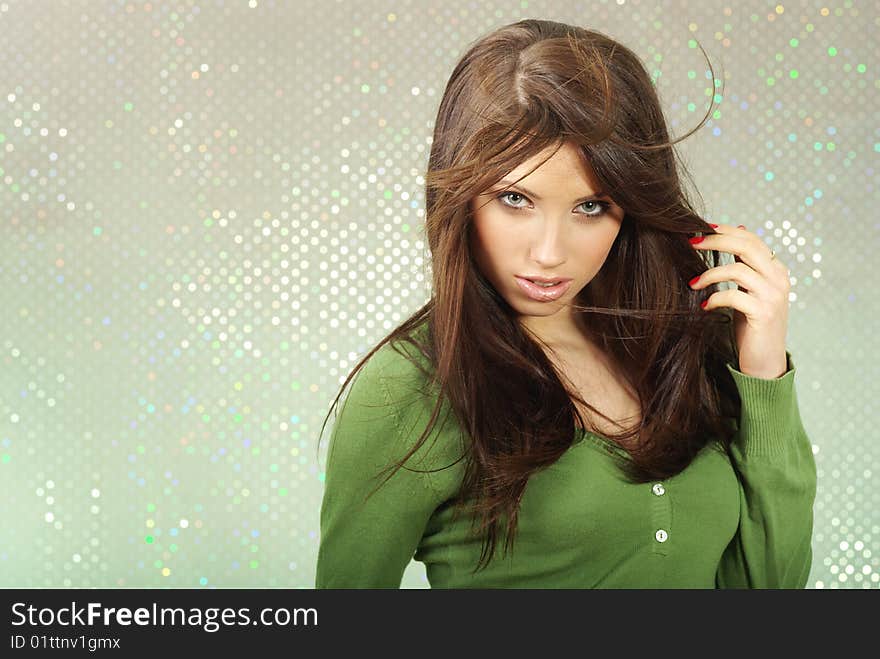 Glamour portrait of a beautiful girl over green background. Glamour portrait of a beautiful girl over green background