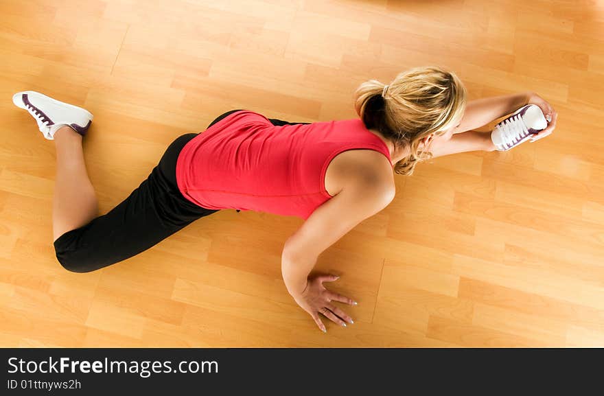 Beautiful blond women exercising on the floor