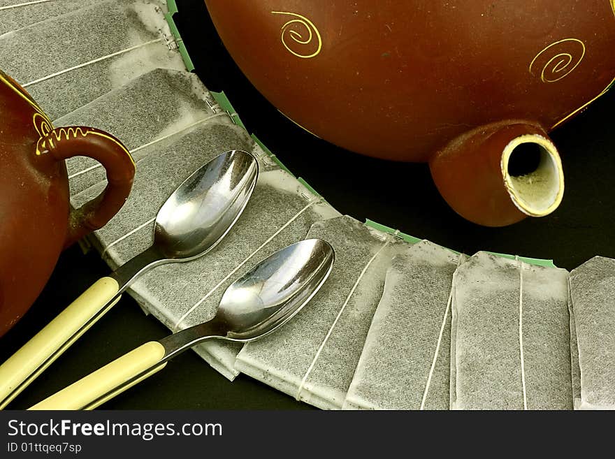 Tea time still life showing teabags spoons and crockery