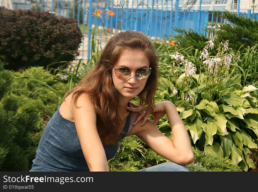 Flirting girl sitting in a park