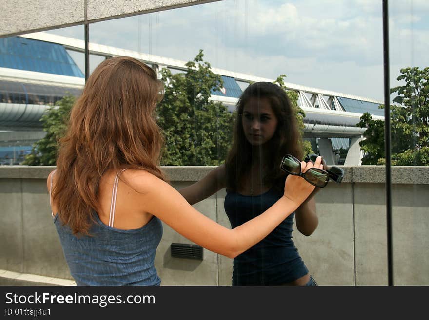 Girl looking at her reflection outdoor