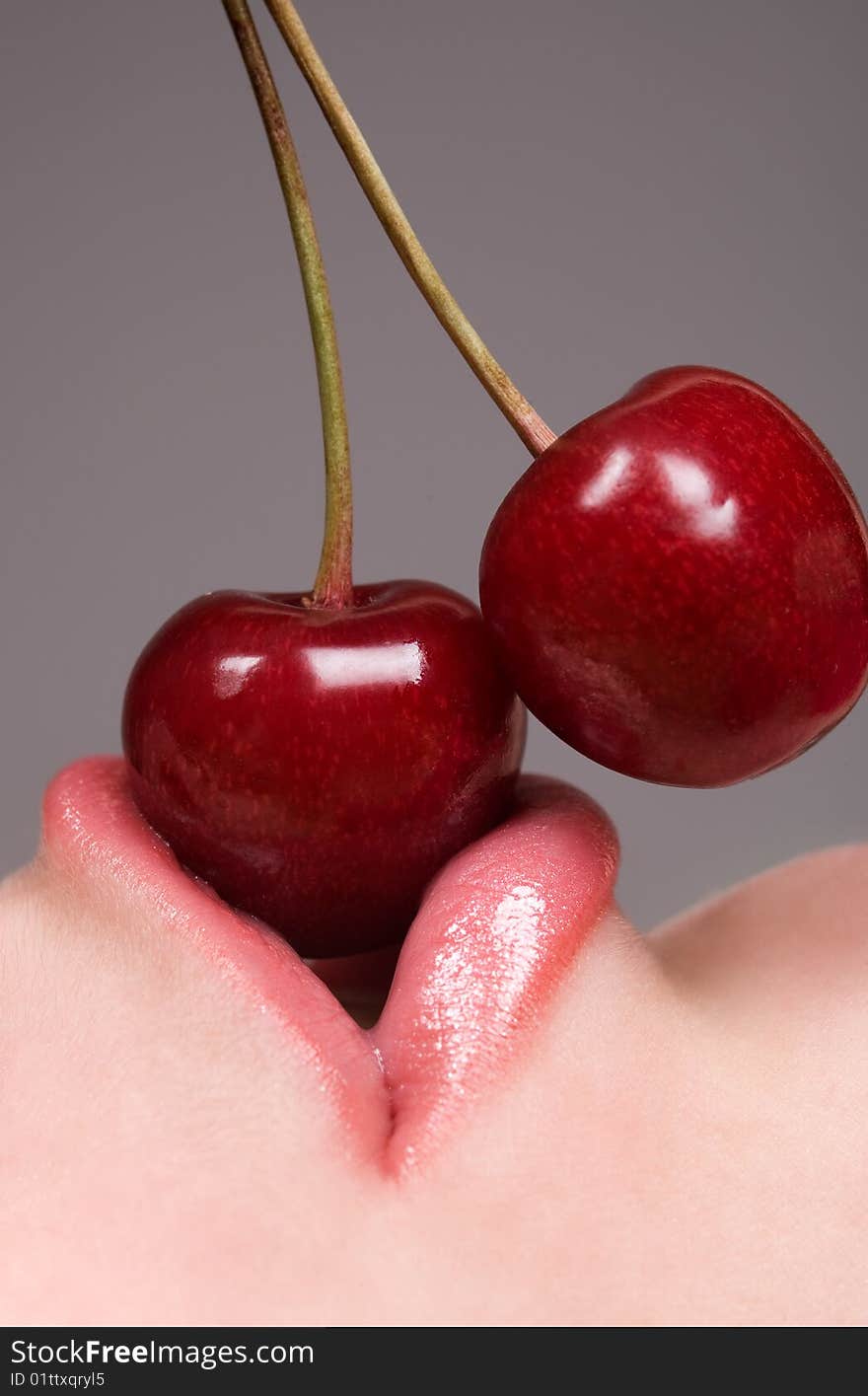 Healthy young woman eating red cherries