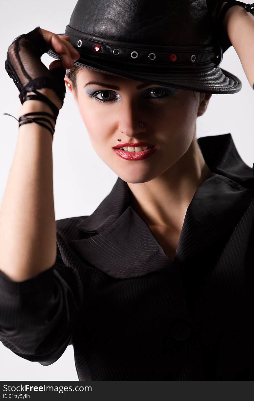 Young fashionable woman with black hat over white. Young fashionable woman with black hat over white