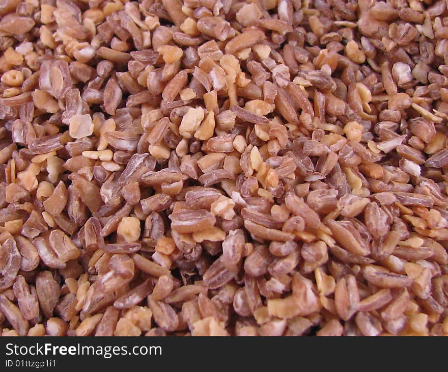 A close-up macro image of bulgur wheat grains. A close-up macro image of bulgur wheat grains.