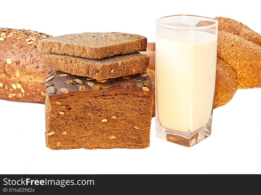 Different bread arranged on table close up with milk. Different bread arranged on table close up with milk