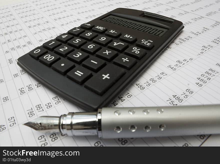 Calculator and pen on a white background. Calculator and pen on a white background