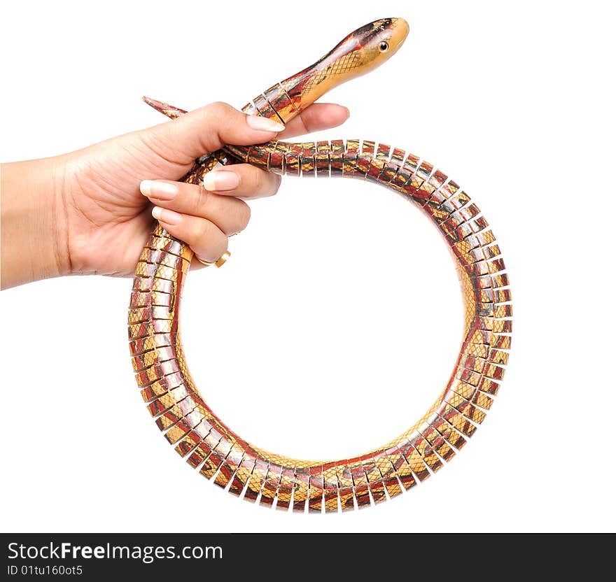 Female hand holding wooden snake. Female hand holding wooden snake.