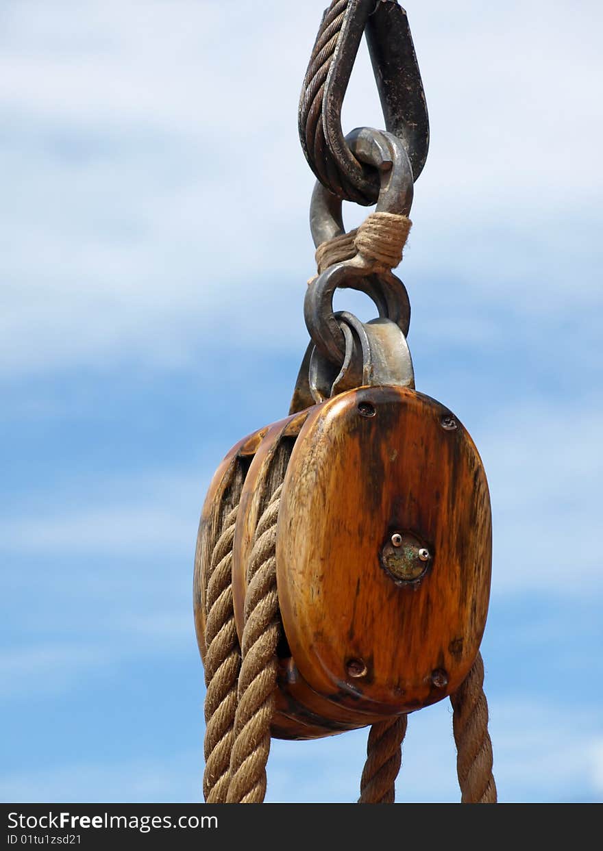 Up close of wooden block and ship rigging. Up close of wooden block and ship rigging