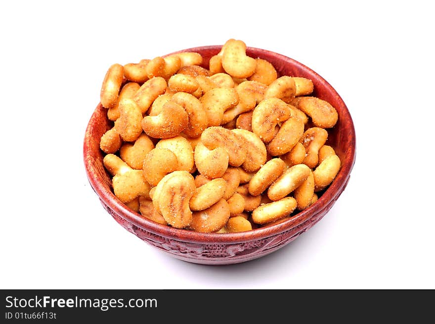 Cashew-nut shaped biscuits in wooden bowl.