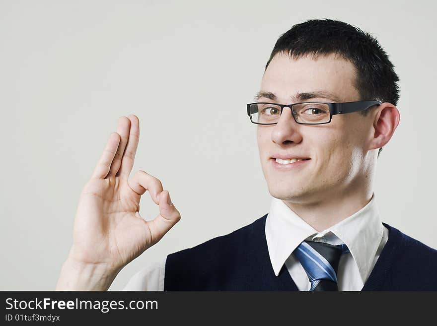 Young businessman showing ok sign