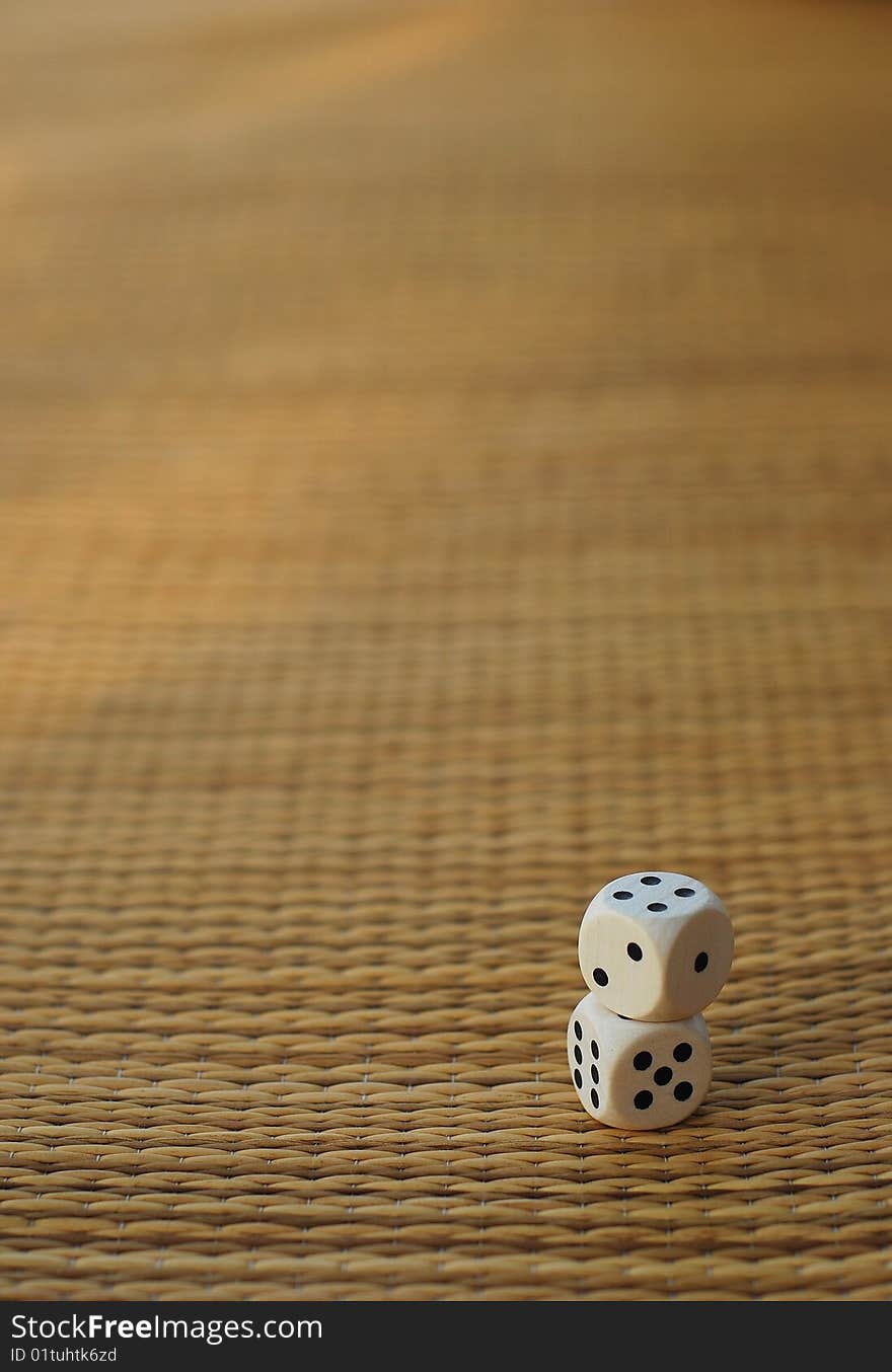 Two dices on a bamboo mat. blurry background