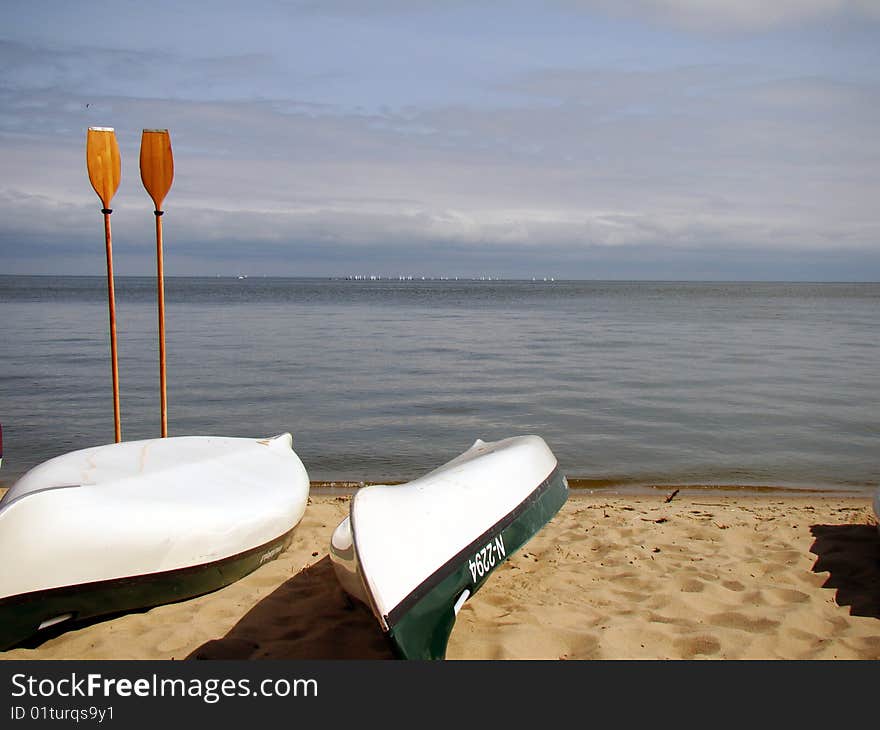 Wooden rowers and boats on shore