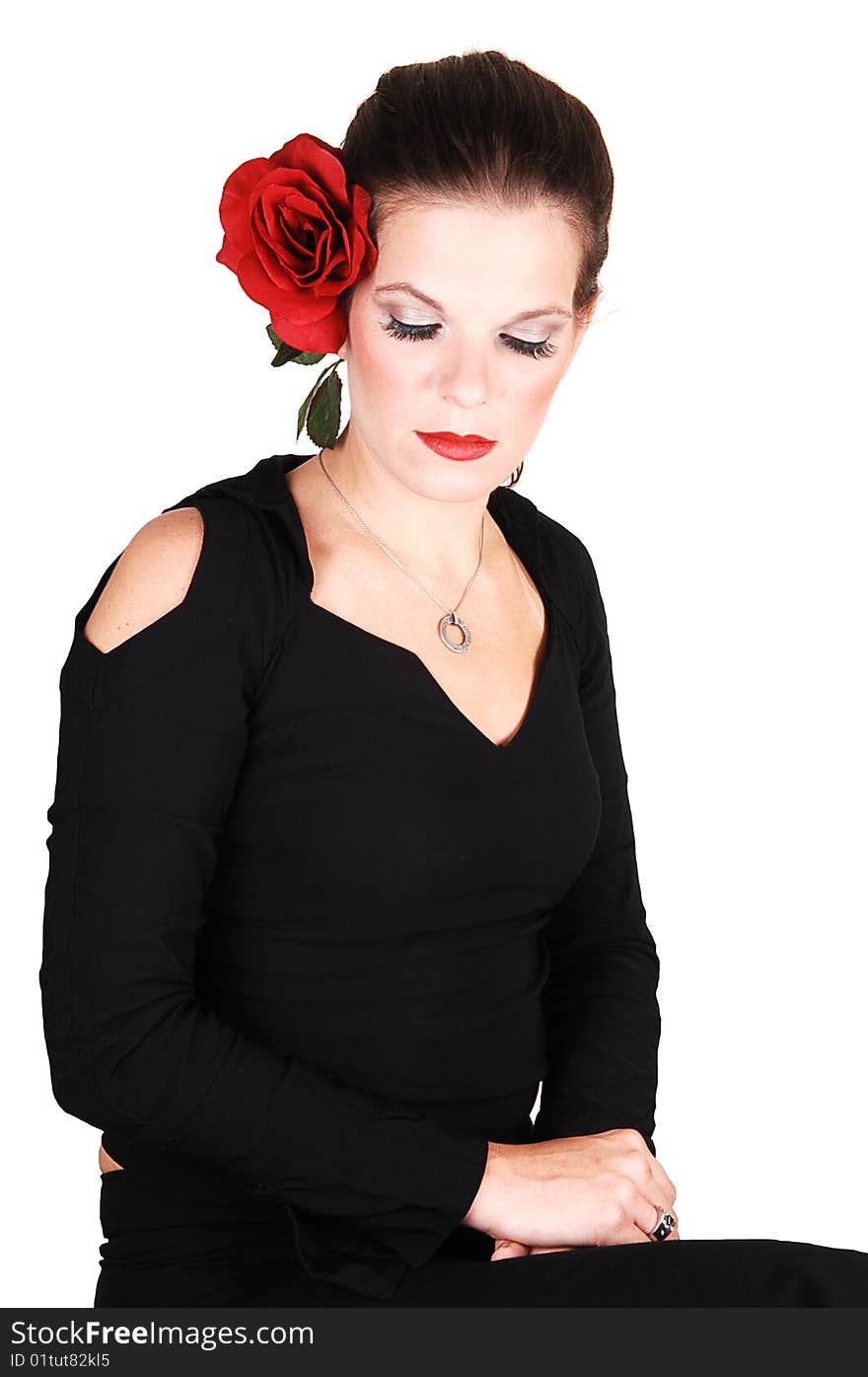 Young light red haired woman in an black dress sitting in the studio whit a 
red rose in her hair, for white background. Young light red haired woman in an black dress sitting in the studio whit a 
red rose in her hair, for white background.