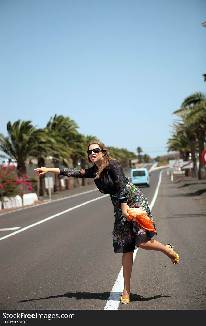 The woman tries to stop the car on road