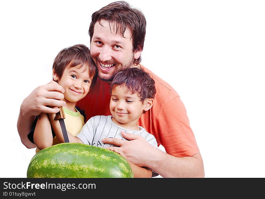 Happy father and two kids preparing watermelon