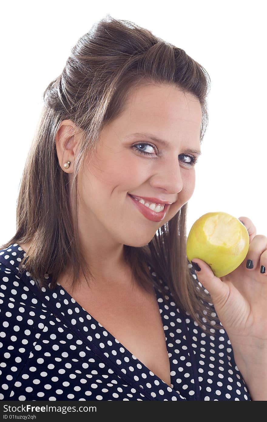 Young smiling woman holding a golden delicious apple with a bite taken out of it; isolated on a white background. Young smiling woman holding a golden delicious apple with a bite taken out of it; isolated on a white background.