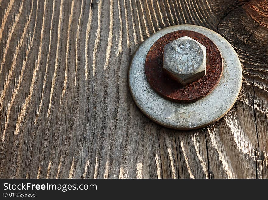 Texture shot of bolt on old wood fence.