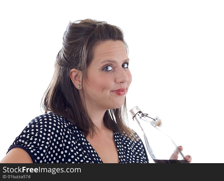 Young woman drinks beverage from an old-fashioned pop-top glass bottle; isolated on a white background. Young woman drinks beverage from an old-fashioned pop-top glass bottle; isolated on a white background.