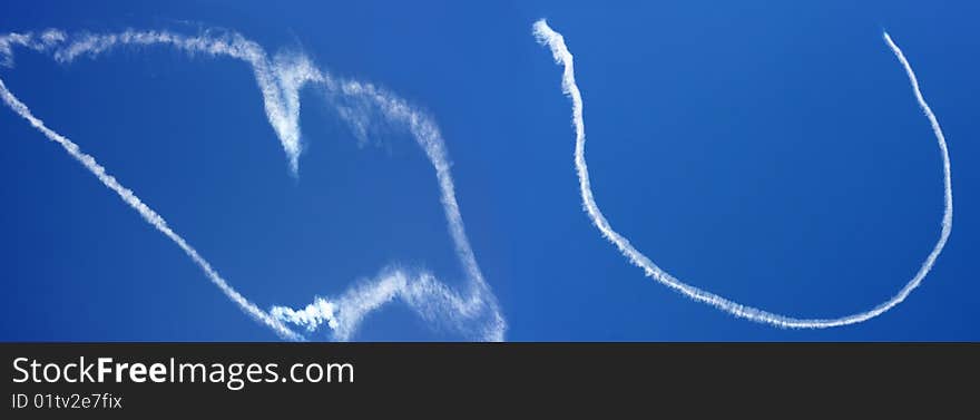 Love you clouds made by a small airplane in the blue sky