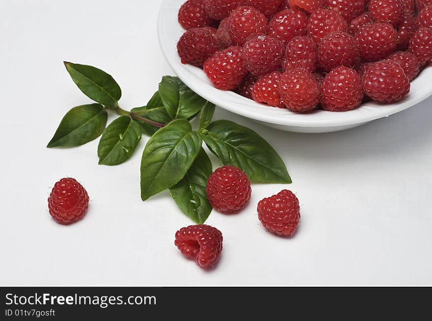 Fresh raspberries in white bowl